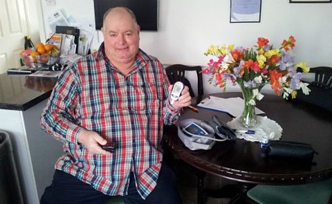 Joe Barr in his kitchen with the Telehealth devices