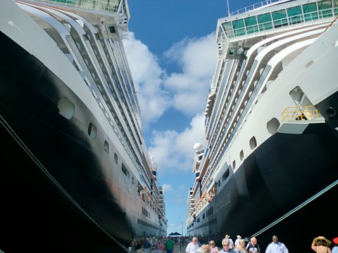 The "Ship of Spies", MS Eurodam, (right) docks in Grand Turk