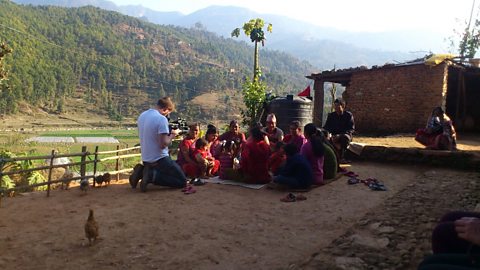 Filming Sumina leading a community meeting