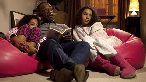 Tony reads a bedtime story to his daughters when there's a knock on the door