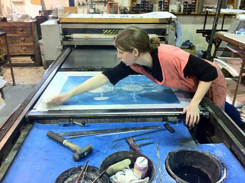Mary, the print assistant at the Curwen cleaning the on the lithographic press
