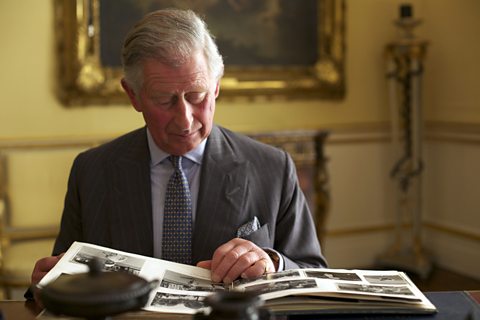 HRH The Prince of Wales reviewing The Queen's photograph albums at Buckingham Palace