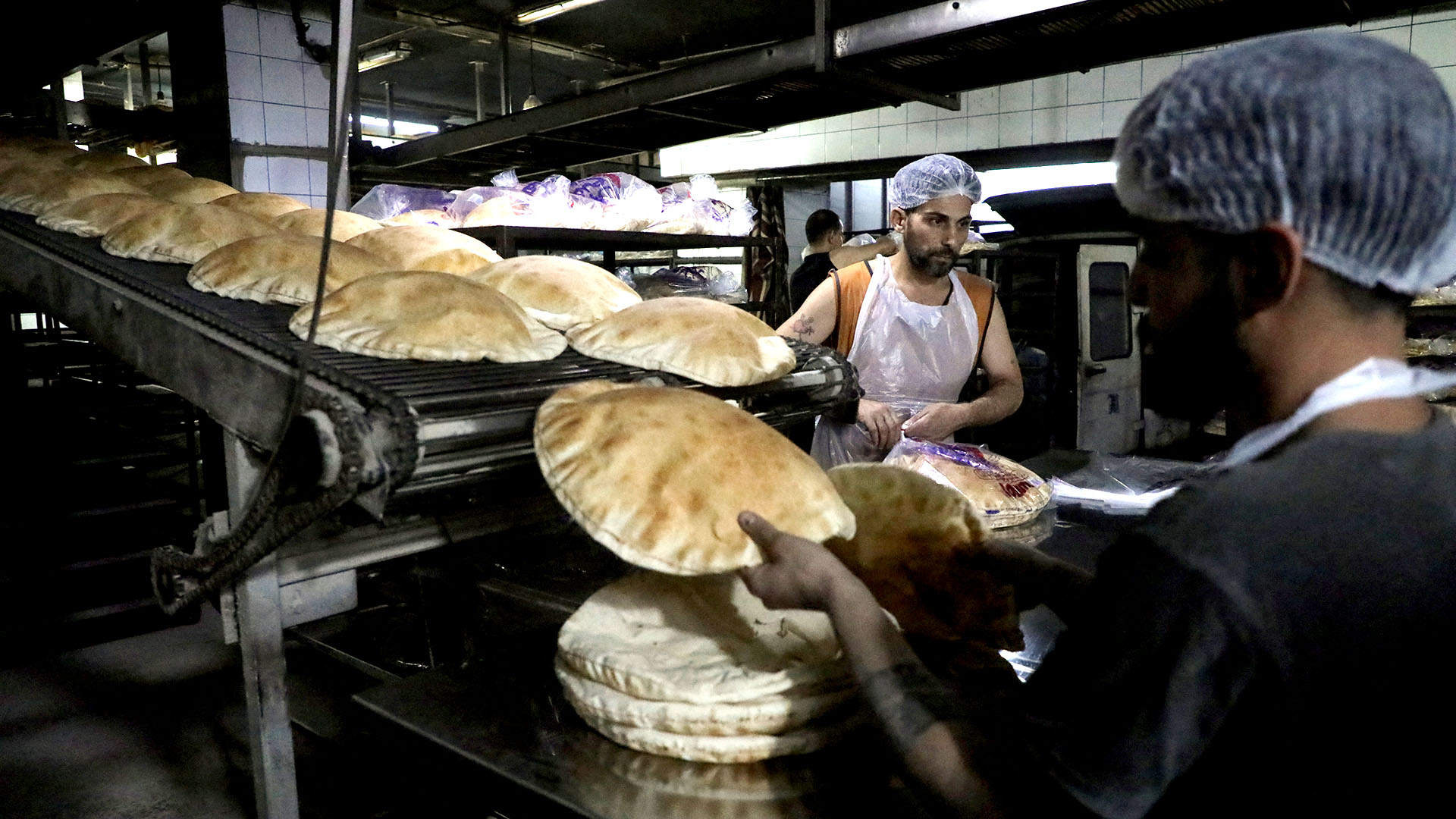 Workers pack freshly baked bread at a bakery in Beirut, Lebanon, March 2022 (Credit: Mohamed Azakir/Reuters)