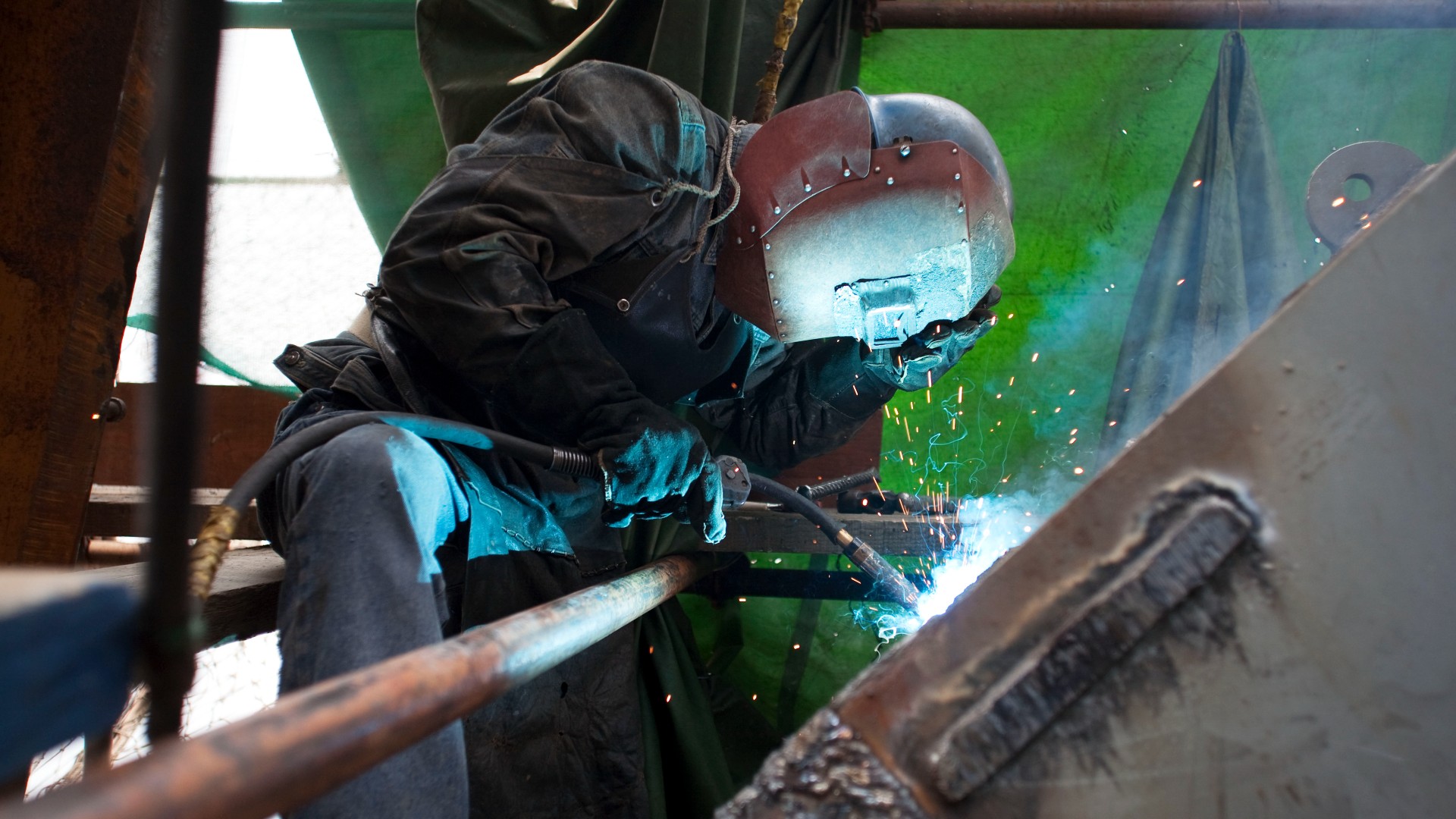 A welder in Beijing, China (Credit: Ben McMillan/Getty Images)