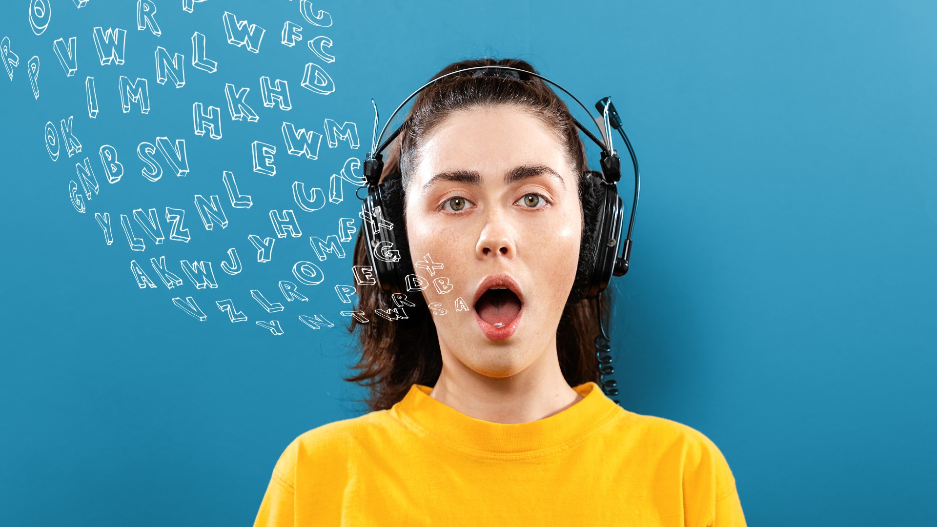 Portrait of a young woman wearing headphones, with her mouth open (Credit: Getty Images)