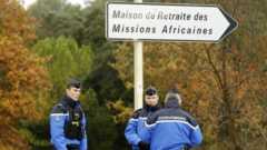 Police stand guard along a security area near a retirement home for Catholic missionaires in Montferrier-sur-Lez
