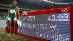 Wayde van Niekerk by the stadium board