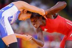 Isabelle Sambou of Senegal (red) and Carol Huynh of Canada compete in the Women's Freestyle 48 kg Wrestling on Day 12 of the London 2012 Olympic Games
