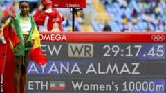 Almaz Ayana by the stadium score board