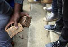A student holds rocks during clashes with the South African police at Johannesburg"s University of the Witwatersrand, South Africa, October 4,2016
