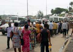 People wait for taxis and buses in Libreville