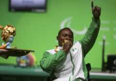 Roland Ezuruike (NGR) of Nigeria kisses his gold medal following men"s Paralympic Powerlifting competition