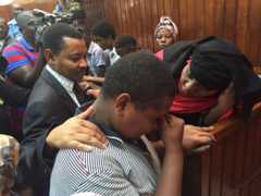 Mrs Rogo comforts her son in court in Mombasa, Kenya