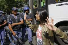 A student from Wits University reacts in front of anti riot police force during the 3rd day of #feemustfall demonstration, against fee increases at universities across the country were announced, in Johannesburg, South Africa, 21 September 2016