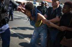 A student from the University of the Witwatersrand (Wits) is detained by South African police forces following clashes during a protest against the university fee increase on September 21, 2016 in Johannesburg, South Africa