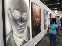 People looking at works on show at FNB Joburg Art Fair