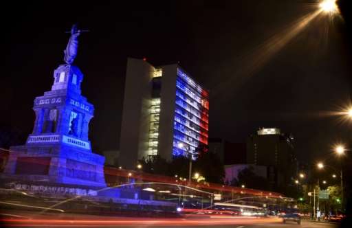 Mexican Senate building (R) is illuminated with the colors of the French national flag on July 14, 2016 in Mexico City in solidarity following the deadly attack in Nice, France.