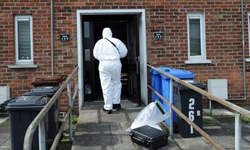 Forensic officer examining George Gray's flat in the aftermath of his murder