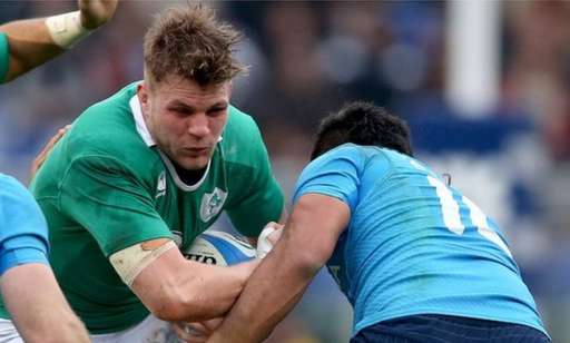 Jordi Murphy attempts to barge past Italy's Kelly Haimona in Rome