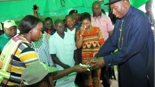 President Goodluck Jonathan receives his voting credentials at a polling station in Otuoke, Bayelsa state, 28 March 2015