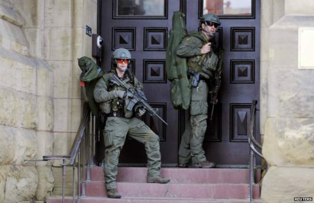 Armed RCMP officers on patrol close to the parliament building after the shooting incident - 22 October 2014