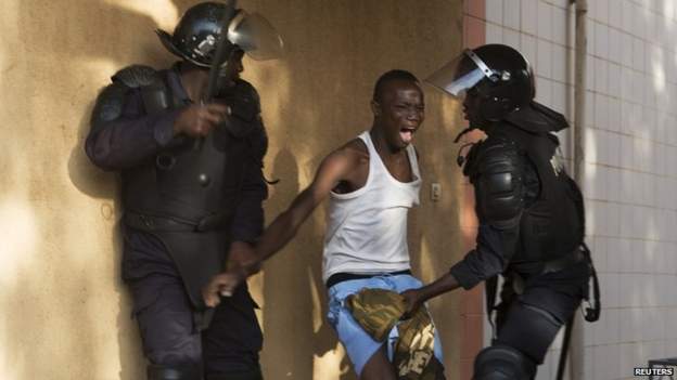 Riot police arrest an anti-government protester in Ouagadougou, capital of Burkina Faso, 30 October 2014.