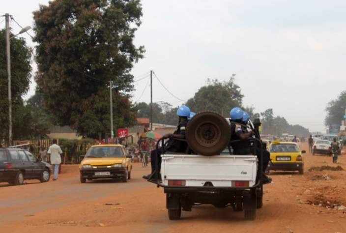 Soldiers of the UN force known by its French acronym MINUSCA sit on a vehicle on September 15, 2014 in Bangui as the new UN mission officially took charge of peacekeeping operations in the Central African Republic