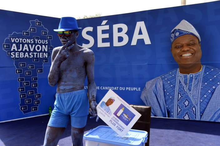 A comedian stands in the campaign stand of presidential candidate and food magnate Sebastien Ajavon on March 3, 2016, in Cotonou. Benin