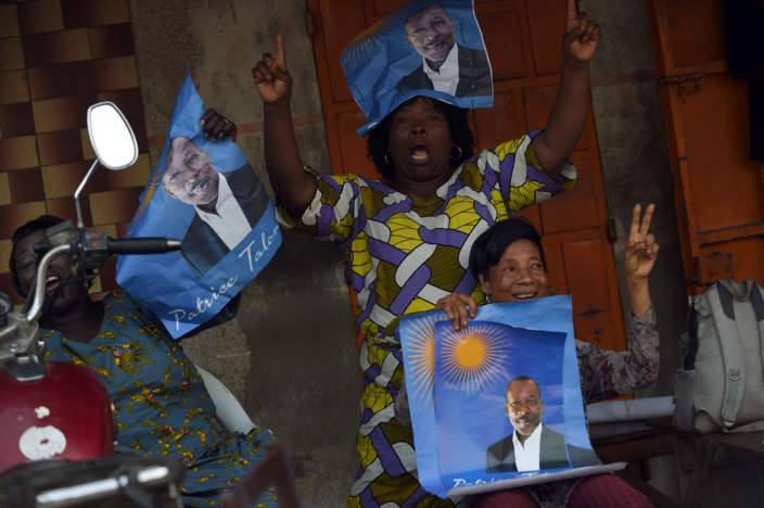 Supporters hold up posters of cotton tycoon and presidential candidate Patrice Talon during a rally in Cotonou, on March 3, 2016. Benin goes to the polls on March 6, 2016 to elect a new president, with a record number of candidates standing, including two of the country's most influential businessmen.