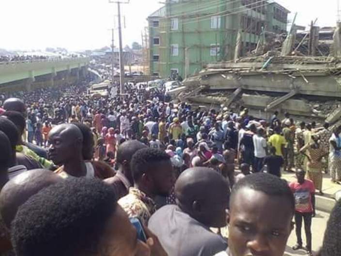 Crowds looking at a shopping mall which has collapsed in Abeokuta, Nigeria