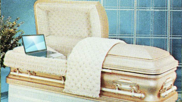 A coffin with a laptop