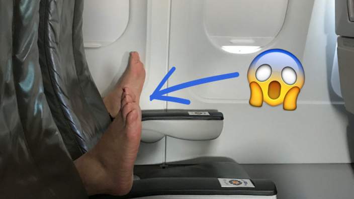 picture of feet on airplane arm rests