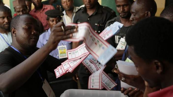 Election officials pull the ballots out of the box at the end of voting in one of the stations in Kaduna, Nigeria - Saturday 28 March