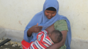 A woman breastfeeding her baby in Somalia.