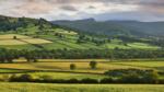 Farmland in the Usk Valley backed by Pen y Fan and Cribyn mountains, Brecon Beacons National Park, Powys, Wales