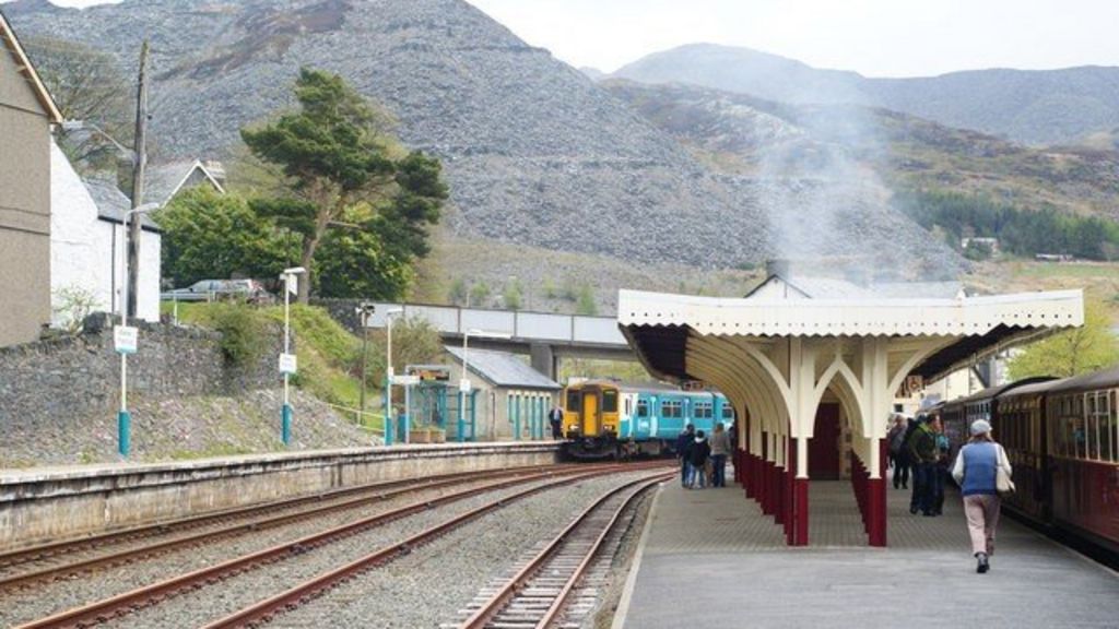 Parents crossing rail tracks with prams