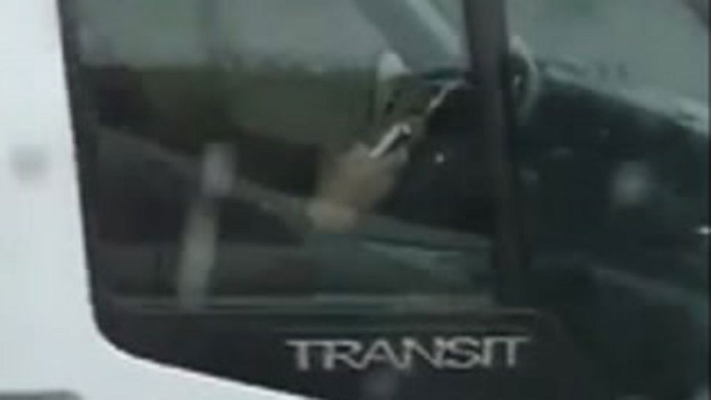 'Texting' police driver filmed