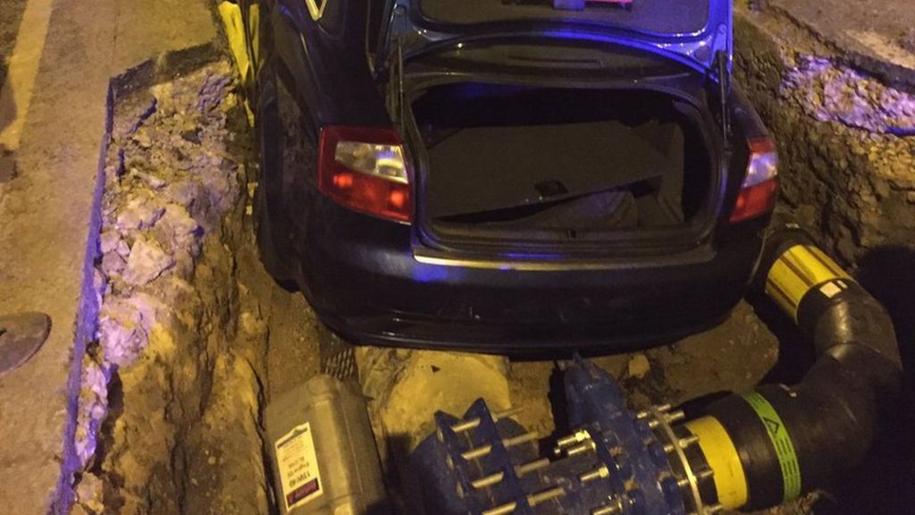 Crashed car lands on gas main in Cradley Heath street trench