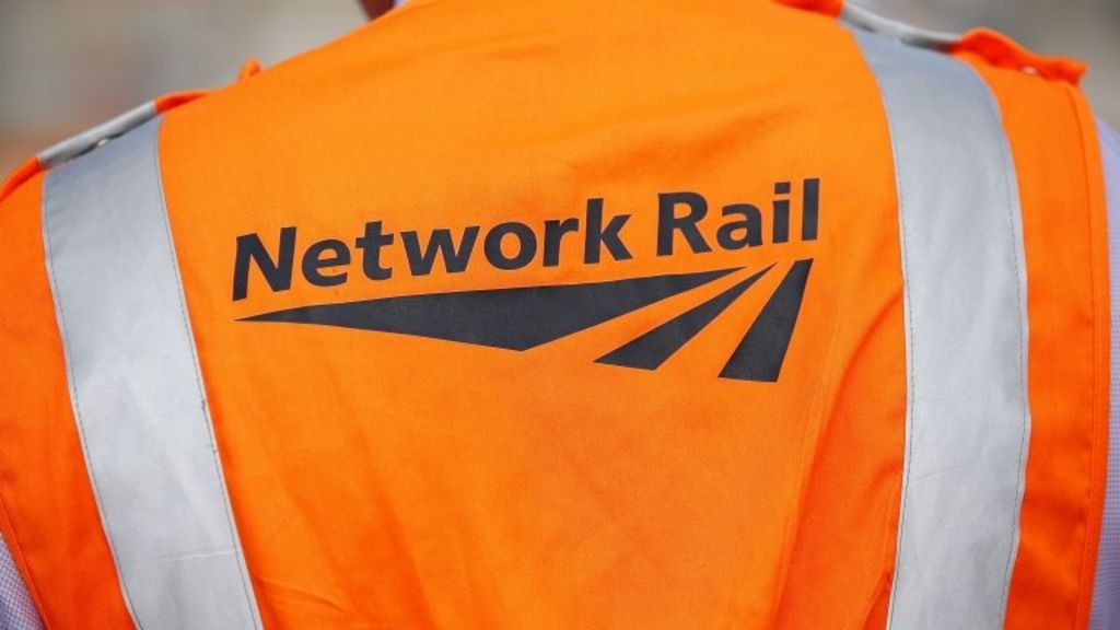 Man held after train hits crossing