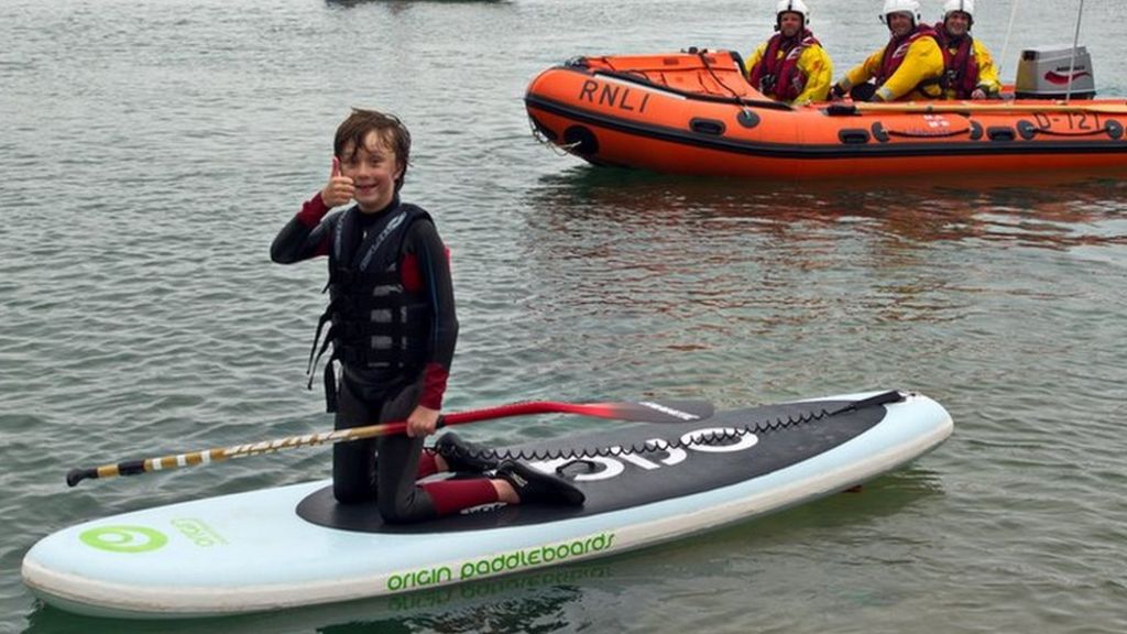 Boy with brain tumour completes paddle board challenge