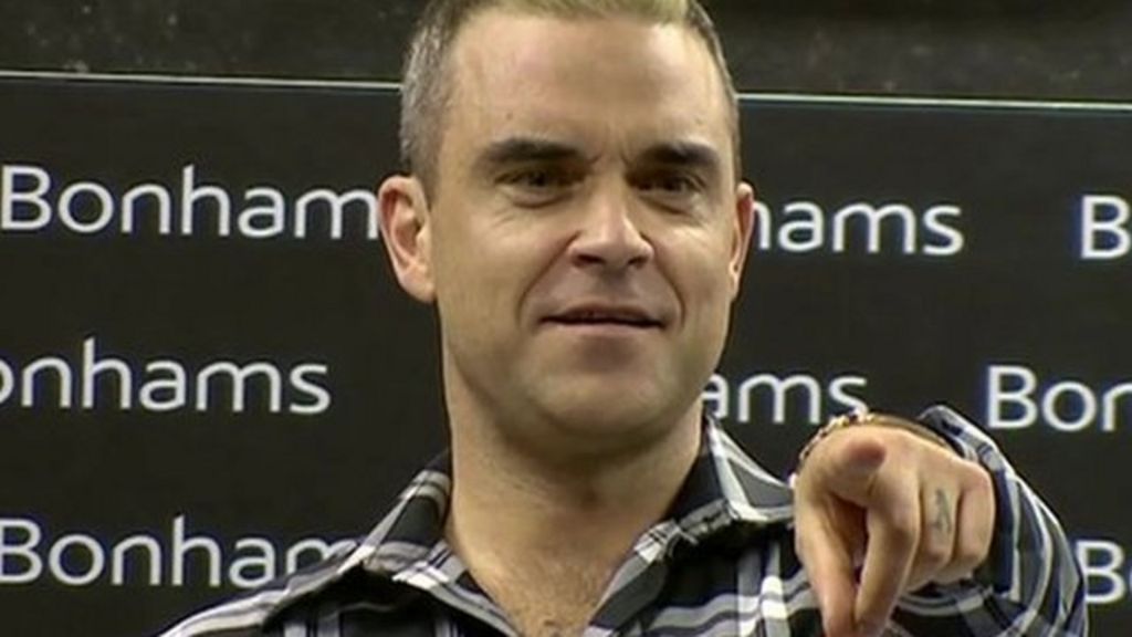 VIDEO: Robbie Williams takes over auction