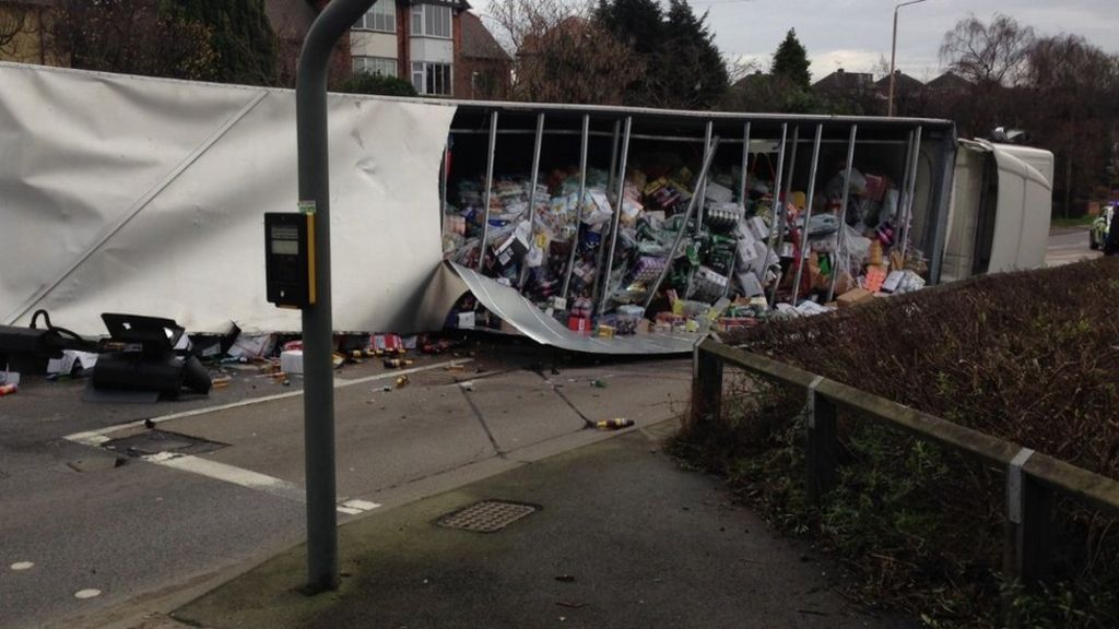 Alcohol in road as lorry overturns