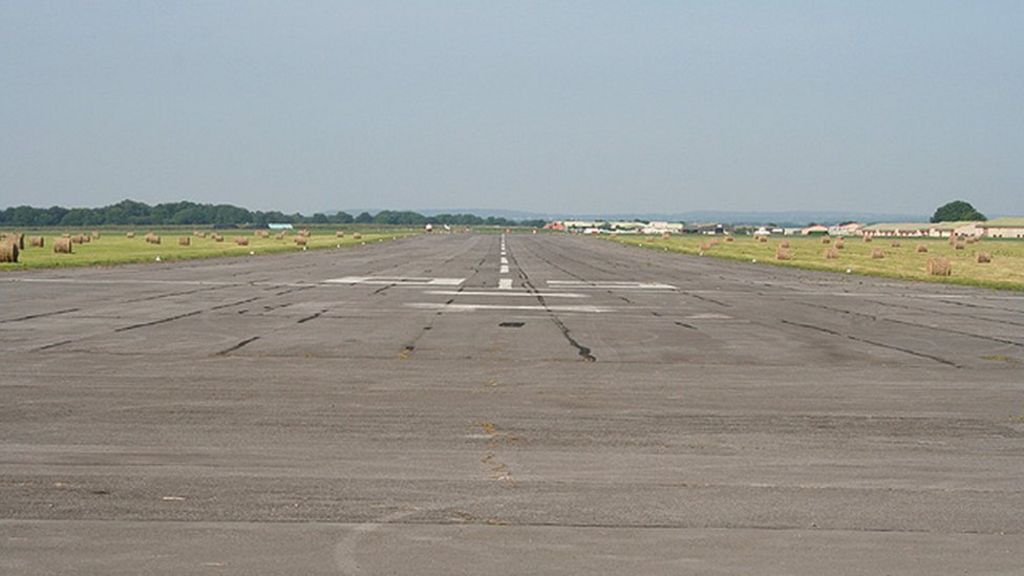 Four dead as plane crashes into field