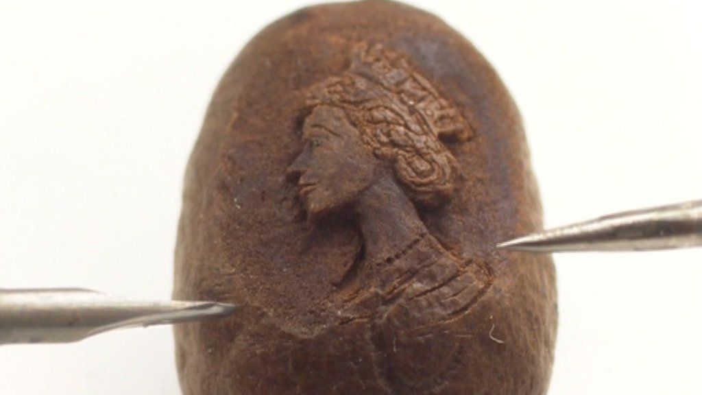 Microportrait of the Queen carved onto a coffee bean BBC News