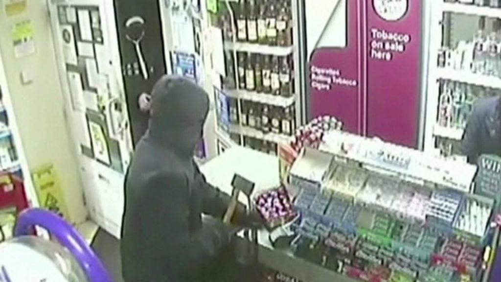 VIDEO: Axe-wielding robber tackled by staff