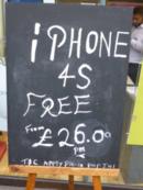 A shop sign saying "iPhone 4s free on £26 pm contract"