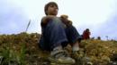 5-year-old Wylie Brys from Dallas sitting on a mound of earth at the site where he uncovered a dinosaur fossil