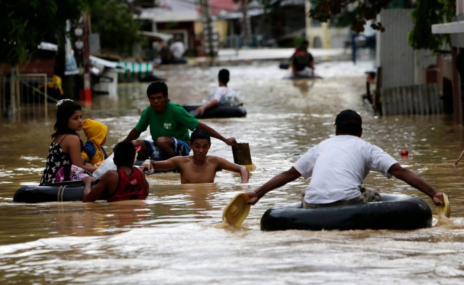 Filipino typhoon victims wade on flood water in Cabanatuan city, northern Manila