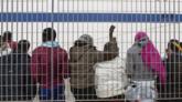 Child migrants wait at the docks on Italy's Lampedusa island