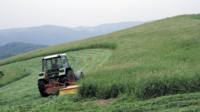 Tractor on grassy slope